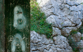column tagged next to a mountain wall