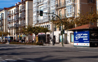 view of a road on a sunny day with store fronts