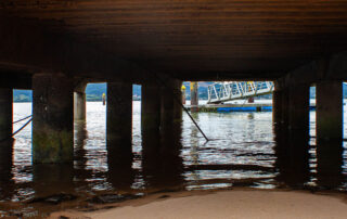 downside view of bridhe with pillars by the sea